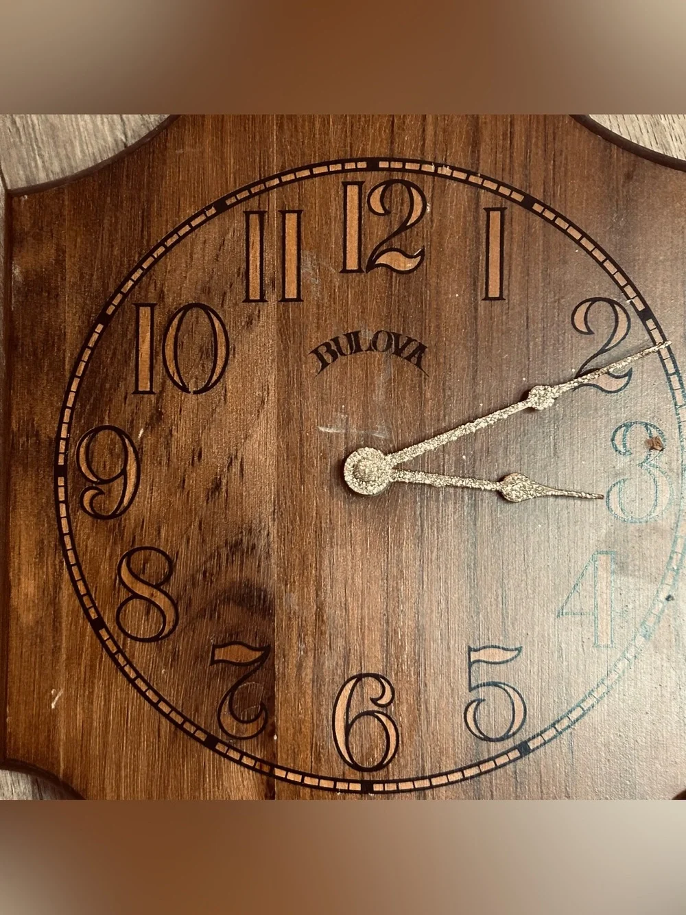 Bulova wall clock features a unique wooden casing shaped like a stylized ship